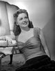 Joan Leslie smiling in a ruffled top photo print.