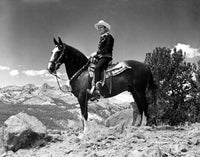 Gene Autry riding a horse in western outfit photo print