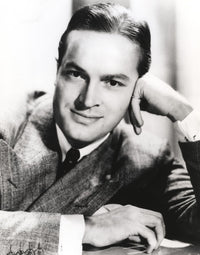 Bob Hope portrait photo print leaning on hand in formal coat.