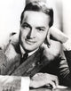 Bob Hope portrait photo print leaning on hand in formal coat.