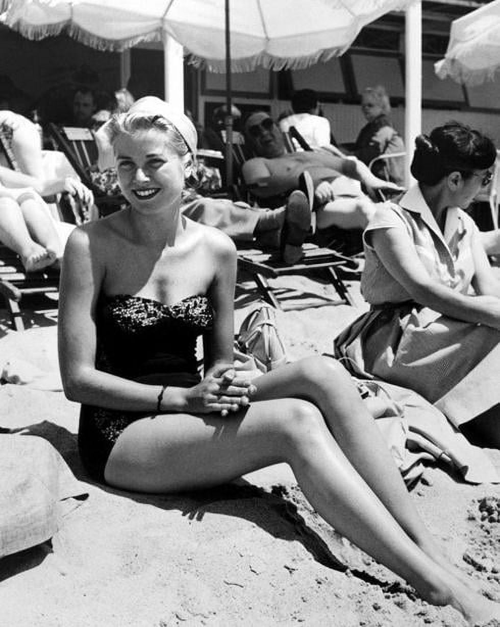 Grace Kelly sitting on beach in black bathing suit photo print