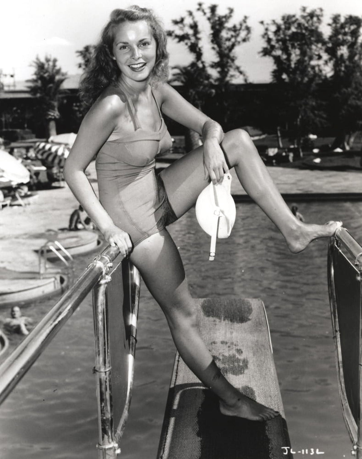 Janet Leigh vintage photo print in grey swimsuit posing by the pool.