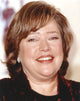 Kathy Bates smiling in a formal outfit photo print