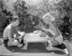 Douglas Fairbanks Jr. and Joan Crawford playing backgammon photo print