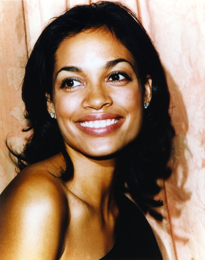 Close-up portrait photo print of Rosario Dawson smiling.