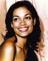 Close-up portrait photo print of Rosario Dawson smiling.
