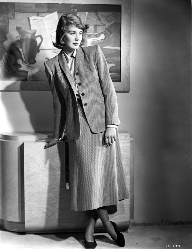 Betsy Drake posed in a grey suit photo print showing elegance and style.