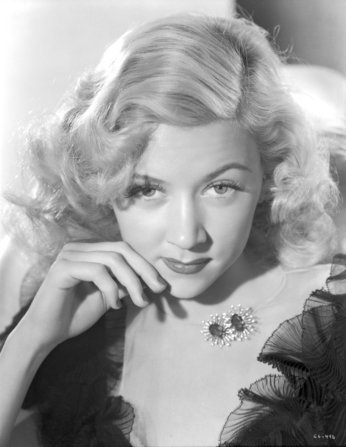 Portrait photo print of Gloria Grahame with curly hair in elegant pose.