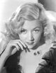 Portrait photo print of Gloria Grahame with curly hair in elegant pose.
