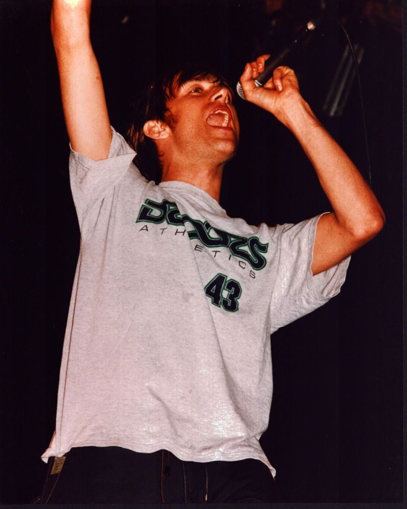 Damon Albarn singing with arm raised photo print