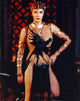 Photo print of Sarah Douglas in a crow printer dress with gold bracelets.