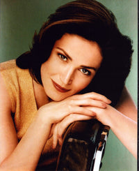 Kim Delaney photo print seated in a gold top, elegant decor piece.