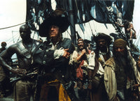 Geoffrey Rush as Hector Barbossa photo print in dynamic pose.