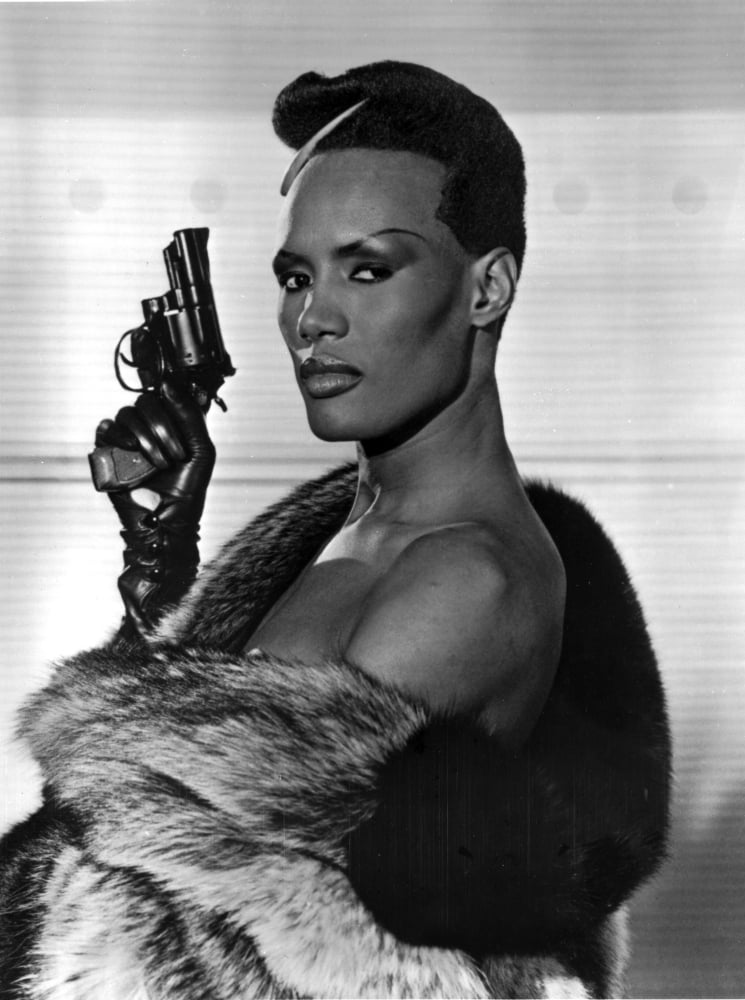 Iconic photo print of Grace Jones holding a pistol, available in multiple sizes.