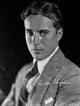 Charlie Chaplin photo print in gray suit and tie.
