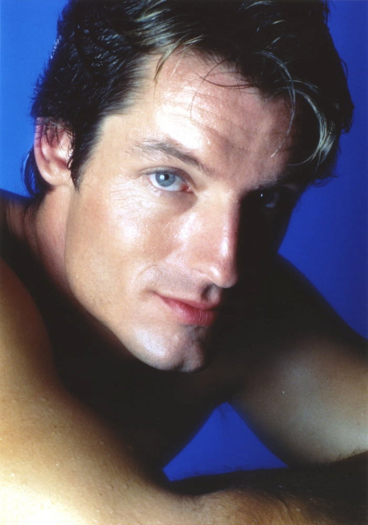 Close-up portrait photo print of Perry King with blue background.