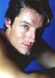 Close-up portrait photo print of Perry King with blue background.