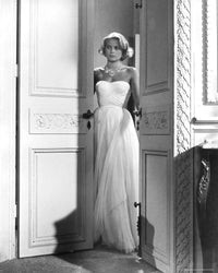 Grace Kelly standing in doorway wearing white dress photo print.