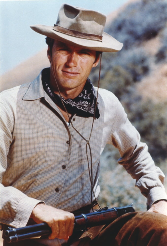 Clint Eastwood posed in cowboy outfit with shotgun photo print.