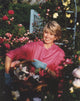 Martha Stewart posed in a flower field portrait photo print.