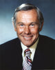 Johnny Carson smiling in suit photo print, available in 8x10 and 16x20 sizes.