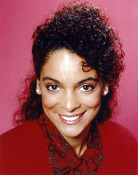 Jasmine Guy smiling in a red coat photo print