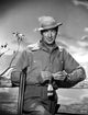 Gary Cooper leaning on fence in Western outfit photo print.