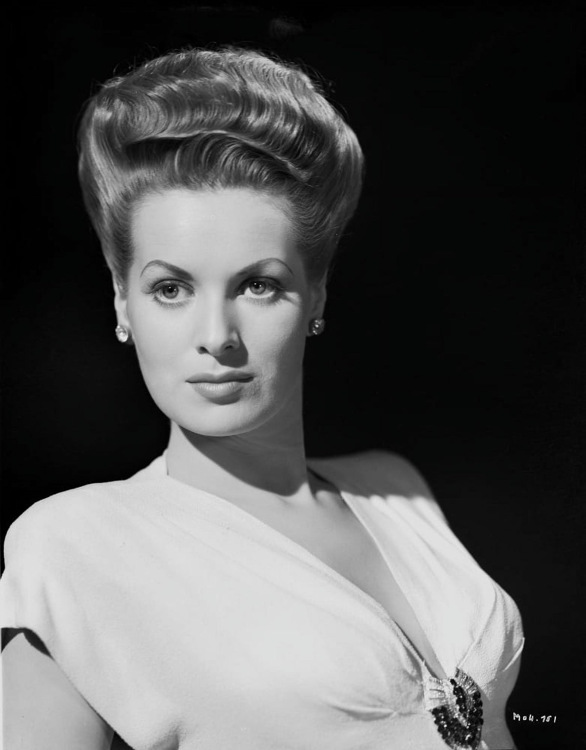 Maureen O'Hara wearing a white V-neck dress on a black background photo print.