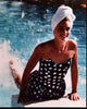 Brooke Shields splashing her feet in a polka dot bathing suit photo print.