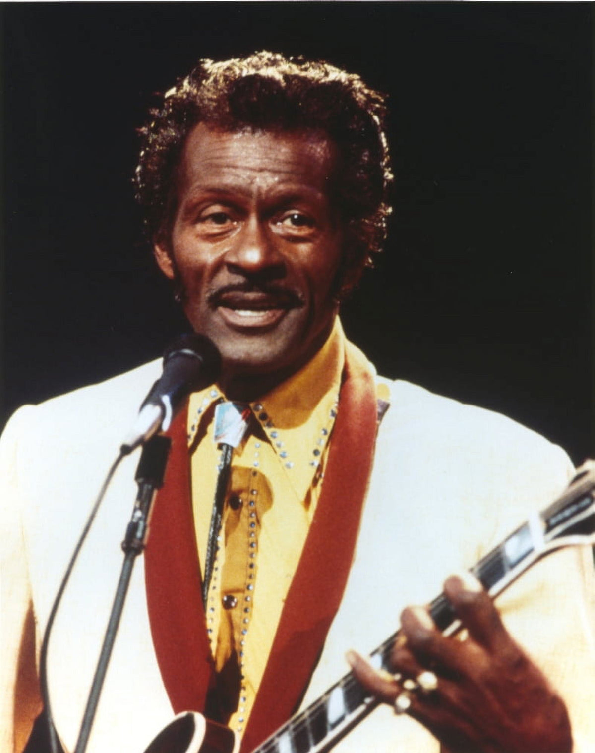Chuck Berry playing guitar in white tuxedo photo print