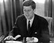 John F. Kennedy sitting at a desk photo print.