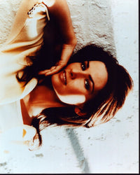 Shania Twain photo print in white with arm raised, perfect for music lovers.