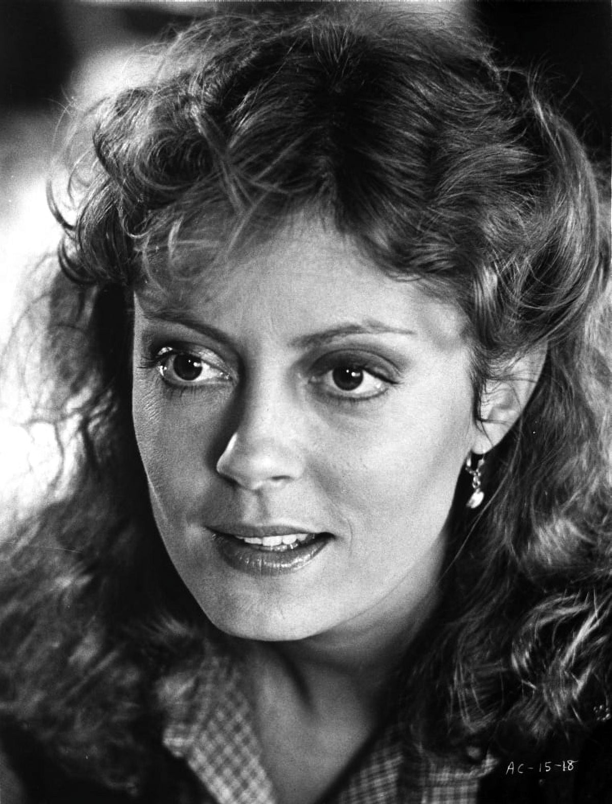 Photo print of Susan Sarandon with curly hair wearing a printed polo.