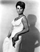 Senta Berger portrait photo print holding a gun.