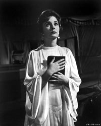 Jean Simmons posed in elegant white butterfly sleeve dress holding a black book photo print.
