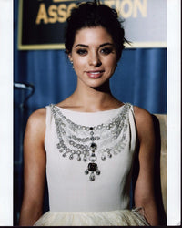 Gia Mantegna elegant photo print in white dress with beaded necklace.