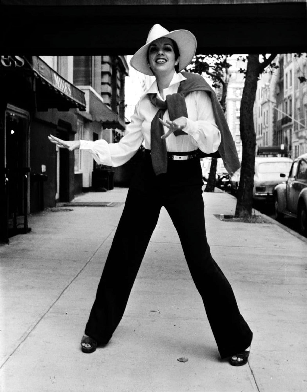 Liza Minnelli wearing a trilby on a sidewalk photo print
