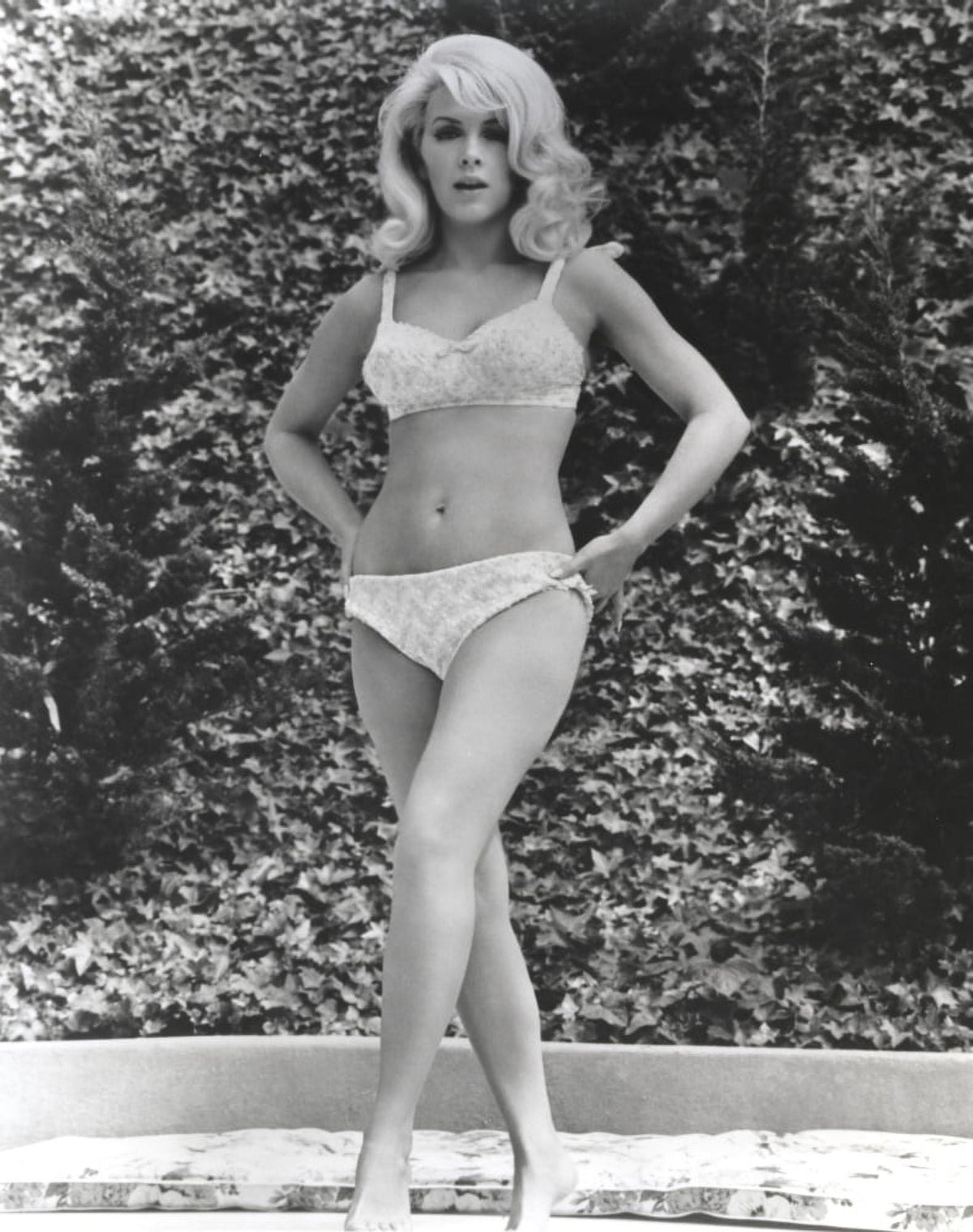 Black and white photo print of Stella Stevens in bikini posing with hands on hips.