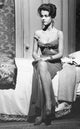 Jane Fonda sitting on bed photo print, classic vintage style.
