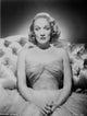 Marlene Dietrich portrait photo print on a couch in a dress.
