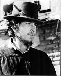 Black and white photo print of Bob Dylan wearing a hat with feather.