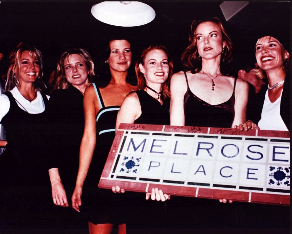 Melrose Place cast members holding Melrose Place sign photo print.