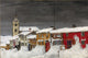 Street in Røros in Winter (1903) art print by Harald Sohlberg depicting a snowy street in Norway.