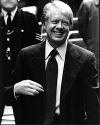 Black and white photo print of Jimmy Carter in striped suit.