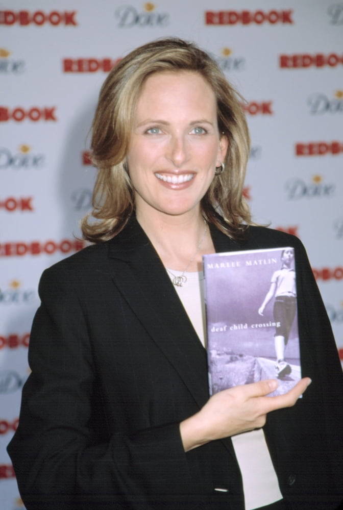 Marlee Matlin holding her book 'Deaf Child Crossing' at Redbook's Mothers & Shakers Awards poster print.