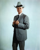 Larry Hagman posed in grey coat with cowboy hat photo print.