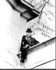 Black and white photo print of Jeremy Brett sitting on a wall, capturing a classic moment.