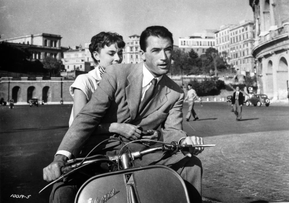 Audrey Hepburn and Gregory Peck riding a motorcycle in Rome photo print.
