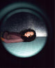 Sandra Oh leaning against a wall in spotlight photo print.