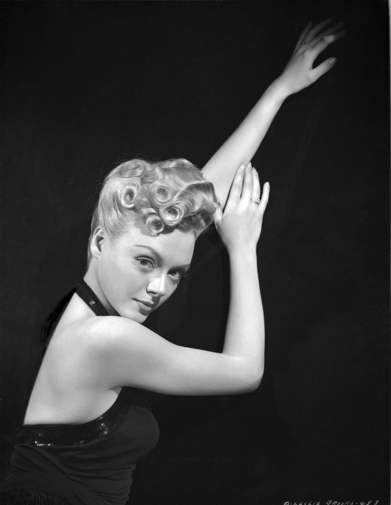 Leslie Brooks posed classic photo print on black background.